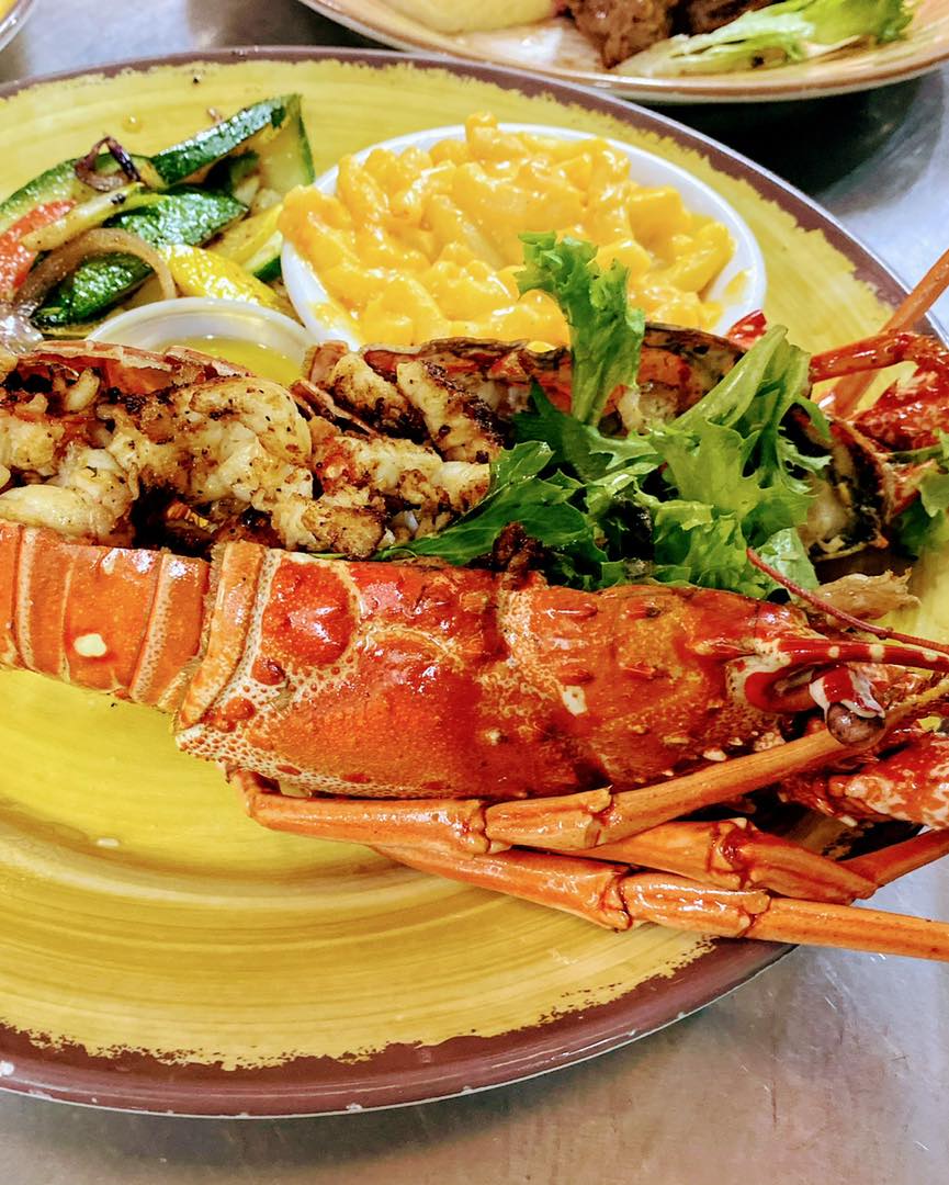 A lobster dish served on a plate, showcasing a delicious and gourmet seafood meal